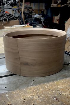 a large wooden bowl sitting on top of a table