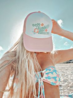 a woman wearing a hat with the words good things are coming on it