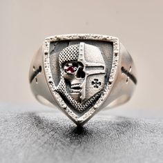 Every similar item seen in others adverts will be considered as an imitative / fake and not made by "Silverzone77" ! NEW KNIGHTS TEMPLAR STERLING SILVER RING 925  The ring is handmade.The face of the ring shows part of a tamplier helmet ,armour and underneath a skull with a red stone in the eye. *Unique design, made by hand. *Each of our items are hand crafted.  *Therefore may have fine speckles or scratches.         * NOTE: Since all gemstones are natural products, photos may have a colour disc Knight Rider Jewelry, Silver Nickel-free Skull Ring As Gift, Knight Jewelry, Nickel-free Silver Skull Ring As Gift, Templar Jewelry, Red Stone, Natural Products, Ring Sterling Silver, Chrome Plating