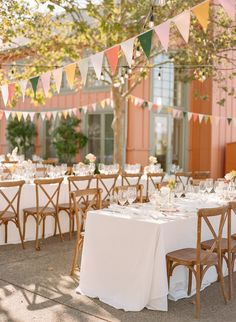 an outdoor dining area with tables and chairs set up for a formal function in the sun