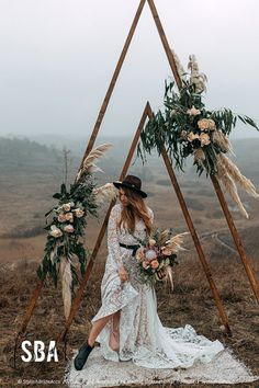 a woman standing in front of a teepee with flowers