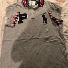 Gray And Black And Red Polo Shirt Very With Ref Strips On The Arms Very Nice Gray Short Sleeve Sporty Polo Shirt, Gray Sporty Short Sleeve Polo Shirt, Casual Gray Polo Collar Shirt, Ralph Lauren Shirts Men, Polo Outfits, Clothes Board, Pink Polo Shirt, Polo Outfit, Royal Blue Shorts