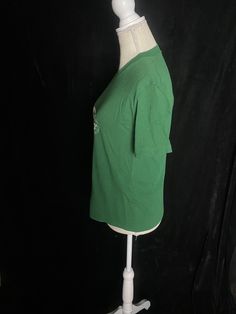 "1970's green shirt sleeve tshirt with white Peter Pan graphic. Some very light pilling throughout entirety of the shirt, shown in photo. Also darker green spot under the graphic, shown in photo Adult medium Chest: 38\" Shoulder to hem: 22.5\"" Retro Green Cotton Top, Green Crew Neck Cotton Shirt, Green Cotton Crew Neck Shirt, Retro Green Cotton Shirt, Green Retro Cotton Shirt, Green Cotton Shirt With Letter Print, Green Graphic Tee Cotton T-shirt, Green Graphic Cotton T-shirt, Green Cotton Graphic Tee