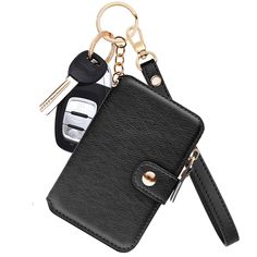 a black leather wallet with two keys and a key chain hanging from it's side