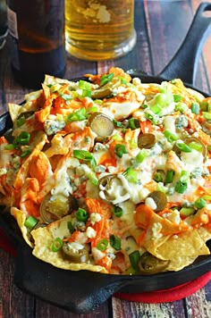 nachos with vegetables and cheese in a skillet