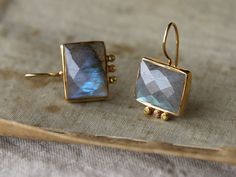 Fantastically styled earrings feature dangling labradorite stones, faceted to show off their deep coloring. Clay Silver Jewelry, Silver Ear Rings, Hammered Hoop Earrings, Labradorite Earrings, Labradorite Jewelry, Square Earrings Studs, Velvet Pillow, Sterling Silver Dangle Earrings, What Am I