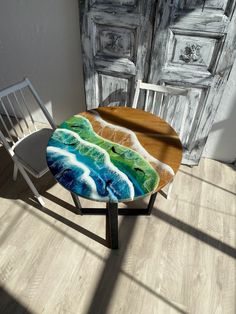 a table and chair with an artistic design on it in front of a wooden door