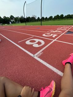 a person sitting on the side of a running track