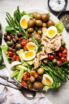 a white plate topped with salad and hard boiled eggs