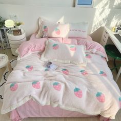 a bed with pink and green fruit print on the comforter, pillows and pillowcases