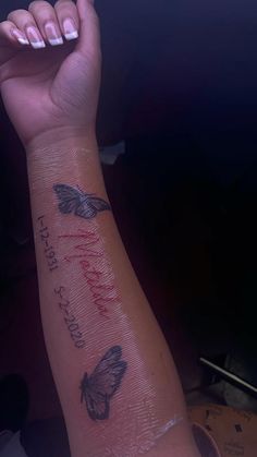 a woman's arm with butterflies on it and the words love you written in red ink