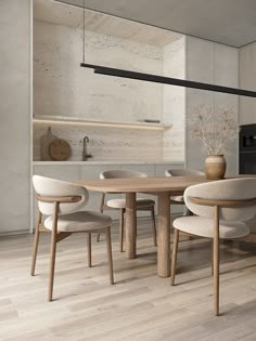 a table and chairs in a room with wood flooring next to a stove top oven