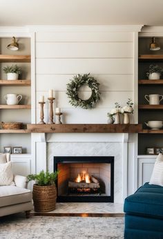 a living room filled with furniture and a fire place in front of a mantle covered in wreaths