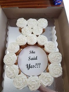 there is a box with cupcakes in it and the words she said yes