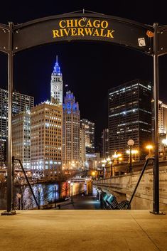 the chicago riverwalk sign is lit up at night