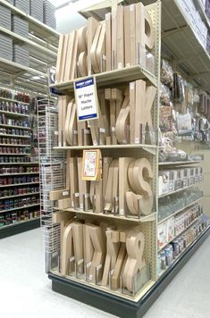 there are many wooden letters on the shelves in this store and one is for sale