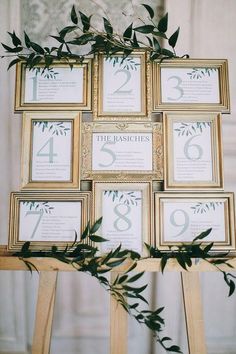 the table numbers were framed in gold frames with greenery on each side, along with an olive branch