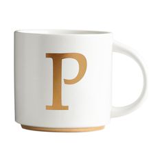 a white and gold coffee mug with the letter p on it