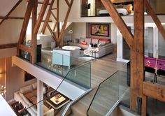 the inside of a house with wooden beams and glass railings