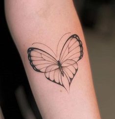 a small butterfly tattoo on the arm