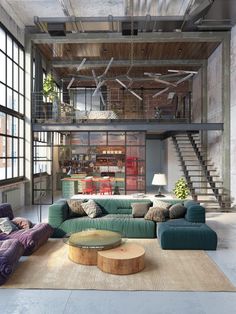 a living room filled with lots of furniture next to large windows and a staircase leading up to the second floor