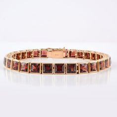 This is a classic style tennis bracelet. A must-have statement piece for every woman. It's a classic luxury to have. A perfect gift for your loved ones. -Material - 18K Solid Yellow Gold -Gemstone - Genuine Garnet -Gemstone Weight - 23.510 ct -Gross weight - 20.85 grams Garnet Benefits:- Helps ignite love and passion. Strengthens one's personal energy. Heightens creativity and inspiration. Improves one's daily energy levels. Establishes faith and trust. Opens the heart. Builds self-esteem. Promo 18k Gold Bracelet, Personal Energy, Daily Energy, Garnet And Gold, Gold Armband, Garnet Bracelet, Birthstone Bracelet, January Birthstone, Birthstone Bracelets