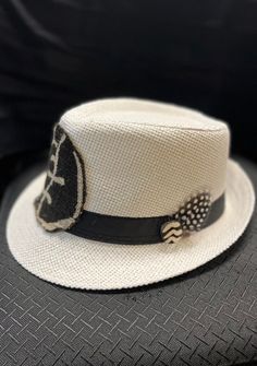 This African Print Fedora is beautiful and unisex. The fedora looks great for the summer with a touch of cowrie shell and feather Comfortable fits small to med size heads.Don't delay order yours today. White Fedora With Short Brim For Festivals, White Short Brim Fedora For Festival, Casual White Hat Bands For Festivals, White Bohemian Straw Hat For Outdoor, White Bohemian Hat For Outdoor, Bohemian White Hat For Outdoor, White Bohemian Outdoor Hat, Handmade White Fedora For Summer, White Casual Fedora For Country Events