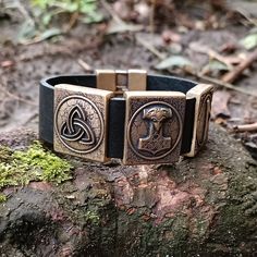 Viking Mjolnir bracelet leather wristband Experience the power of the Norse gods with this Viking leather wristband bracelet featuring Mjolnir, Thurisaz rune and triquetra charms. Handcrafted with premium quality leather, this wrist cuff is a perfect blend of Celtic and Viking style. The Mjolnir charm represents the mighty hammer of Thor, while the Thurisaz rune symbolizes strength and protection. The triquetra charm adds a touch of Celtic flair to this piece. Ideal for men who love Norse and Ce Thurisaz Rune, Hammer Of Thor, Ancient Runes, Norse Gods, Viking Bracelet, Leather Wristbands, Cuff Jewelry, Viking Style, Wristband Bracelet