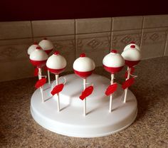 several red and white lollipops sitting on top of a counter