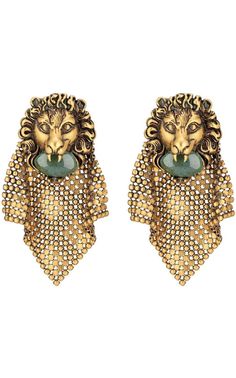 The lion head holds a green cabochon glass stone and is enriched with an intricate diamond-shaped beaded mesh detail. Metal with aged gold finish Lion head with agate green coloured cabochon glass stone Mesh metal detailAntique effect gold-tone hardware, Clip-on Lion head: 35mm x 40mm 86mm total length Material: Brass, cabochon glass stone, leaded crystalMade in Italy Gucci Runway, Chevron Jewelry, Head Chain, Buy Gucci, Chain Mail, Lion Head, Online Earrings, Color Oro, Designer Earrings