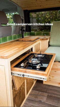 a stove top oven sitting inside of a camper