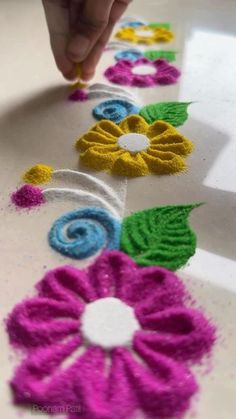 someone is doing something with crochet on the table and it looks like they are making flowers