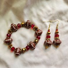 Red and gold bracelet and earrings set, 49ers colors with football beads. Dimensions:  bracelet 8.5 inches earrings 2.5 inches Adjustable Red Beaded Dangle Bracelets, 49ers Colors, Bracelet And Earring Set, San Lorenzo, Purse Charms, Red And Gold, Key Chains, Earrings Set, Red Gold