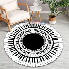 a round rug with piano keys in the center and a potted plant on the side