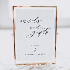 a sign that says cards and gifts on the side of a white tablecloth with gold frame