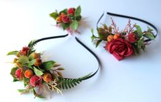 two flower headbands with leaves and flowers on them, one is red and the other is green