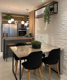 a dining room table with chairs and an oven in the background, next to a kitchen