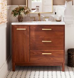 a bathroom with a sink, mirror and rug on the floor in front of it