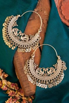 92.5 silver tribal chandbali hoops with half moon pattern highlighted by carved floral peacock motifs and cut-out floral tassels. - Aza Fashions Handmade Chandbalis For Festival, Handmade Chandbali Earrings For Festival, Festival Chandbali Hoop Earrings With Latkans, Traditional Hoop Earrings With Cutdana, Handmade Bohemian Metal Chandbalis, Bohemian Brass Chandbalis For Festive Occasions, Handmade Metal Bohemian Chandbalis, Handmade Bohemian Chandbalis, Bohemian Gold Chandbalis