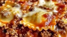 a close up view of some lasagna shells with cheese and sauce on top