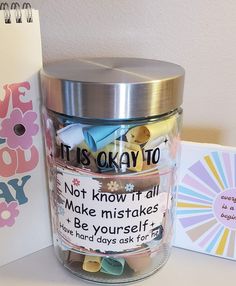 a jar filled with lots of magnets next to a notepad