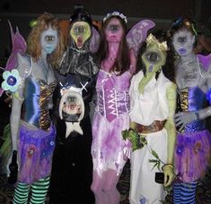 group of people dressed in costumes standing next to each other