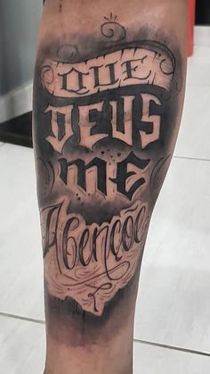 a man's leg with tattoos and lettering on it