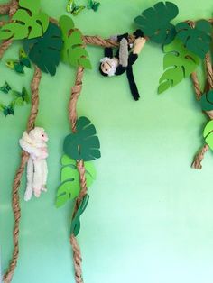 there is a monkey hanging on the rope with other toys in front of it,