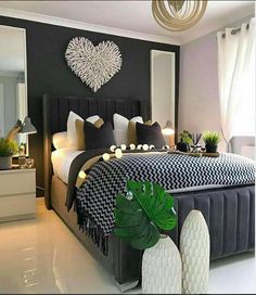 a bedroom with black and white decor on the walls