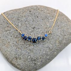 This minimalist Blue Sapphire Necklace features a stunning round gemstone, set in 14K solid gold. Perfect for September birthdays, this piece is sustainably made and adds a touch of elegance to any outfit. Ceylon Sri Lanka, Blue Sapphire Pendant, Blue Sapphire Necklace, Bracelets Gold, Jewelry Appraisal, Jewelry Safe, Sapphire Pendant, September Birthstone, Sapphire Necklace