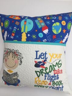 a blue pillow with an image of a child's face on it and the words let your dreams take flight