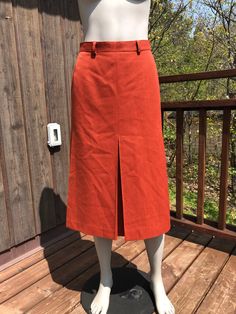 Vintage orange mister Leonard skirt. Made from a polyester and wool blend (40% wool). Fully lined. Has nice large pleats for easier walking. A great burnt orange colour that's great for fall. IN good condition with one light mark on the front.  Fits size small  26-27" waist (27 will be tight) 36" hips 28.5" length Orange Lined Skirt For Workwear, Cheap Orange Relaxed Fit Skirt, Chic Knee-length Orange Skirt, Orange Relaxed Lined Skirt, Orange Mini Length Lined Skirt, Midi Skirt Winter, Skirt Winter, Burnt Orange Color, Orange Skirt