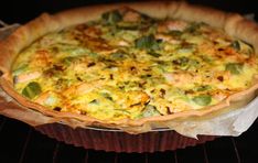 a pizza sitting inside of an oven on top of a pan with toppings in it