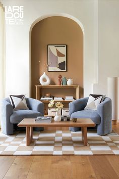 a living room with two blue couches and a coffee table in the center area